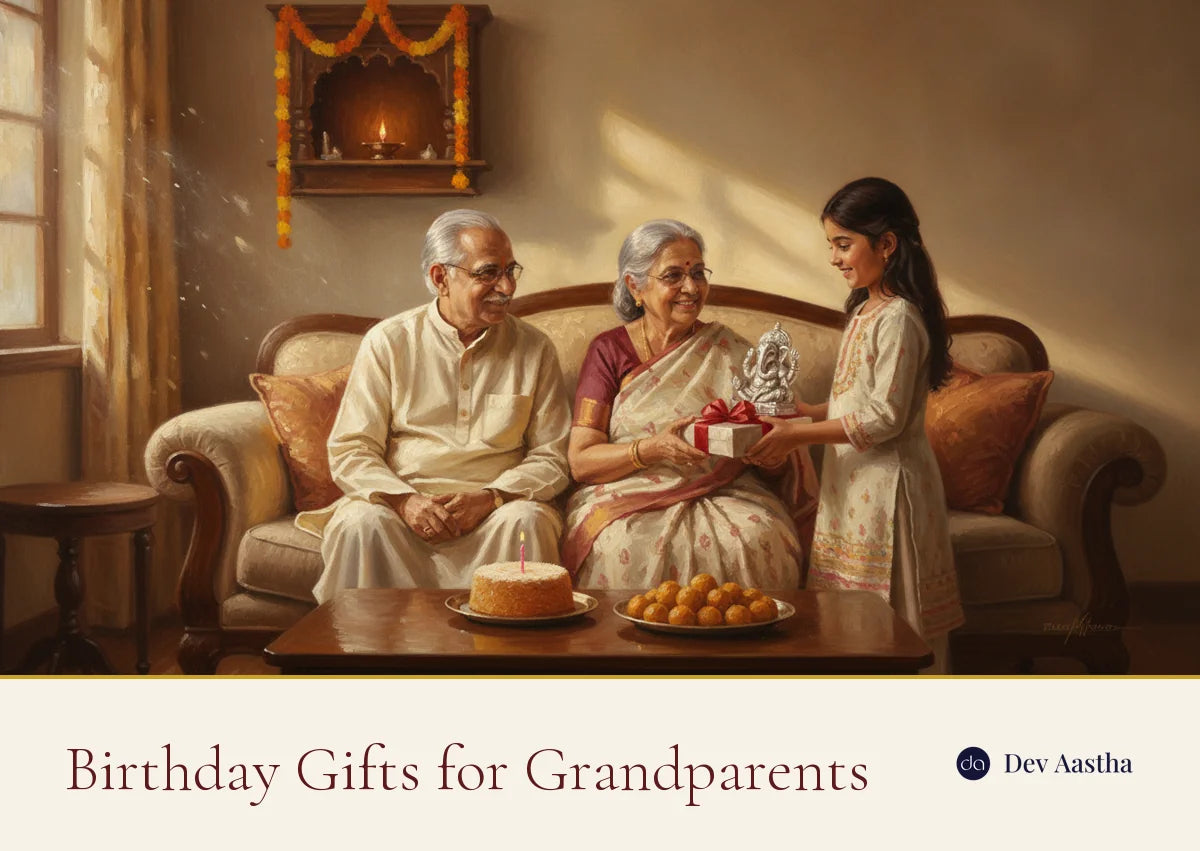 Indian family celebrating a grandfather's birthday at home, a granddaughter handing over a gift box with a silver-plated idol beside a shelf mandir