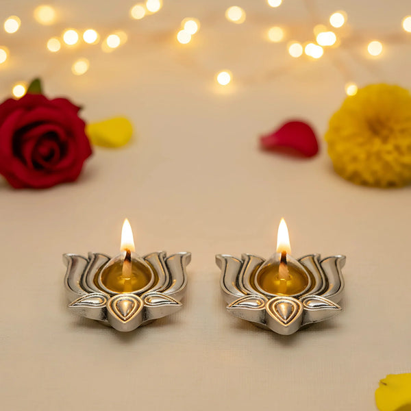 Pair of lit silver-plated lotus diyas with rose, marigold and fairy lights for Diwali decor