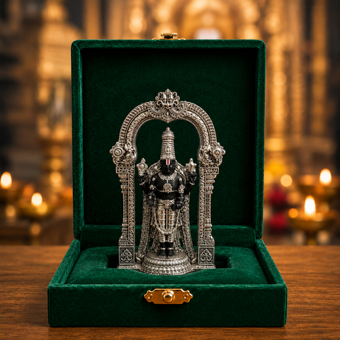 Standing Tirupati Balaji silver-plated idol with ornate arch in green velvet box near diyas