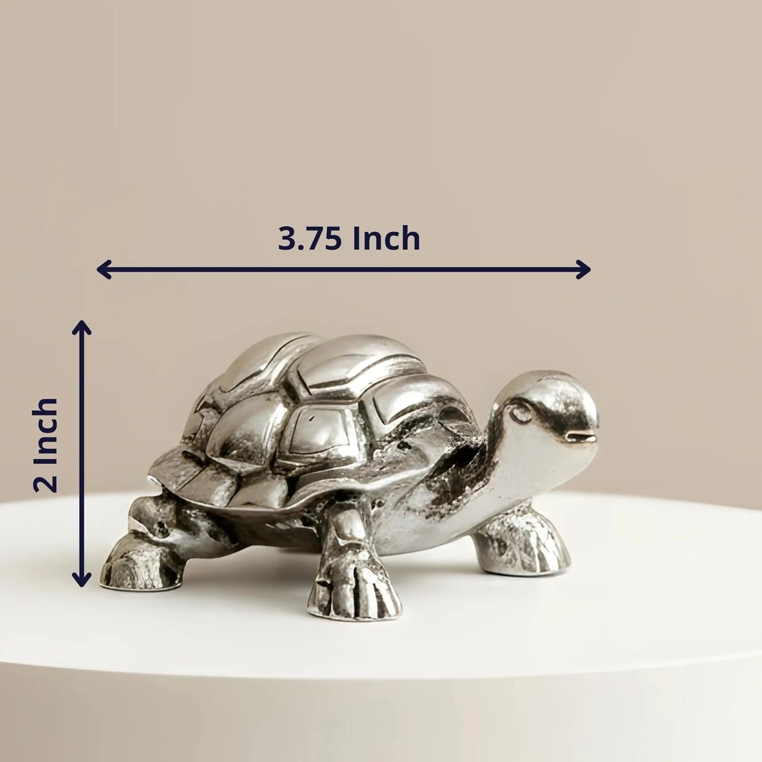 Silver metal turtle figurine measuring 3.75 inches long and 2 inches high on a white surface