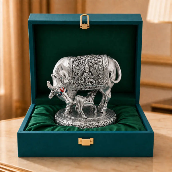 Silver-plated Kamdhenu cow with calf idol, 2.5 inch, seated on satin inside an open teal velvet gift box #2-5-inch