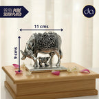 Silver plated cow and calf showpiece measuring 11x9 cm on wooden box with flower petals