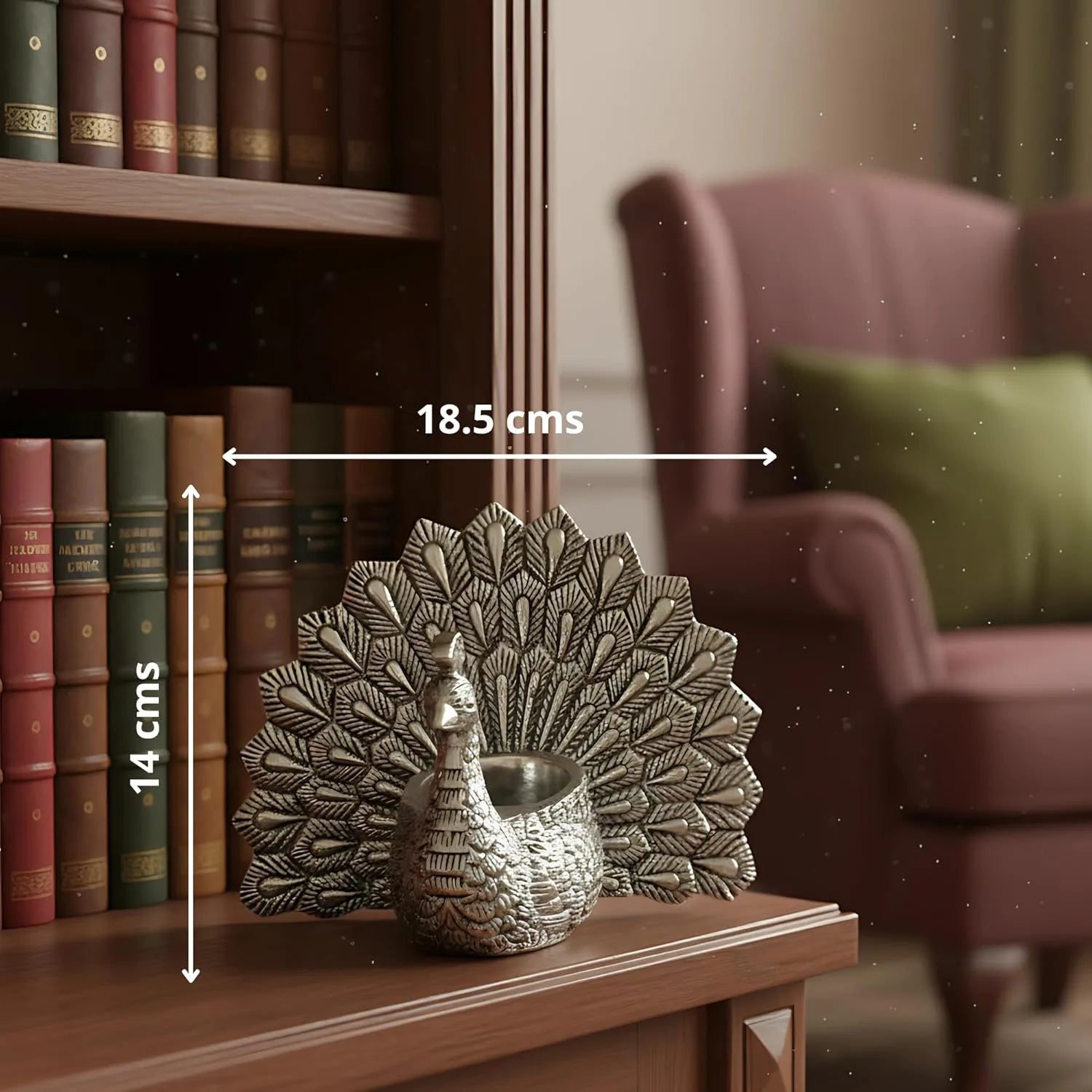 Silver peacock decor with 18.5x14 cm dimensions on wooden shelf near bookshelf and purple armchair
