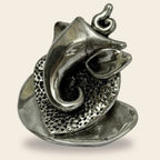 silver Lord Ganesha statue with intricate texture and smooth finish on beige background