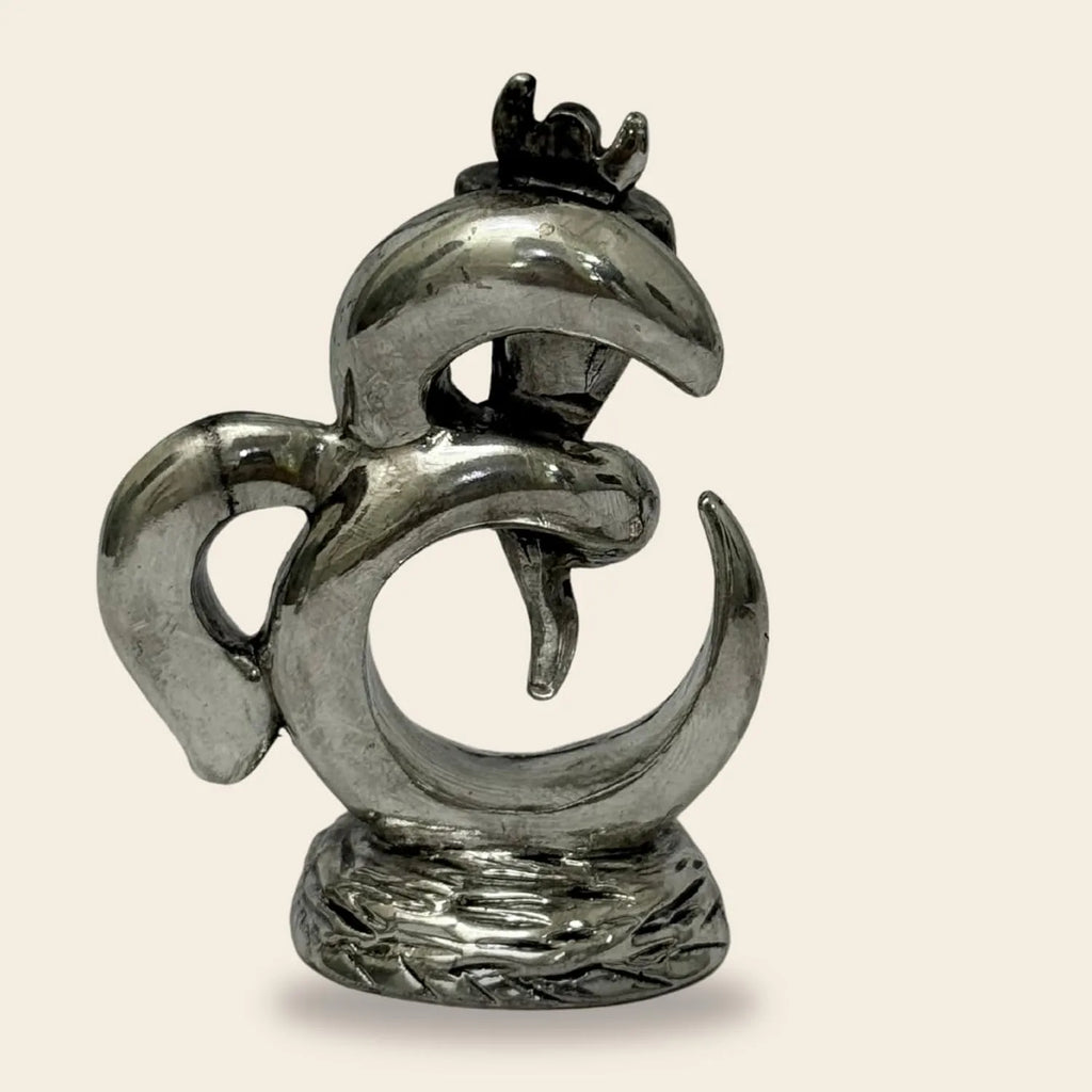 Silver metal abstract bird sculpture with curved shapes on textured base