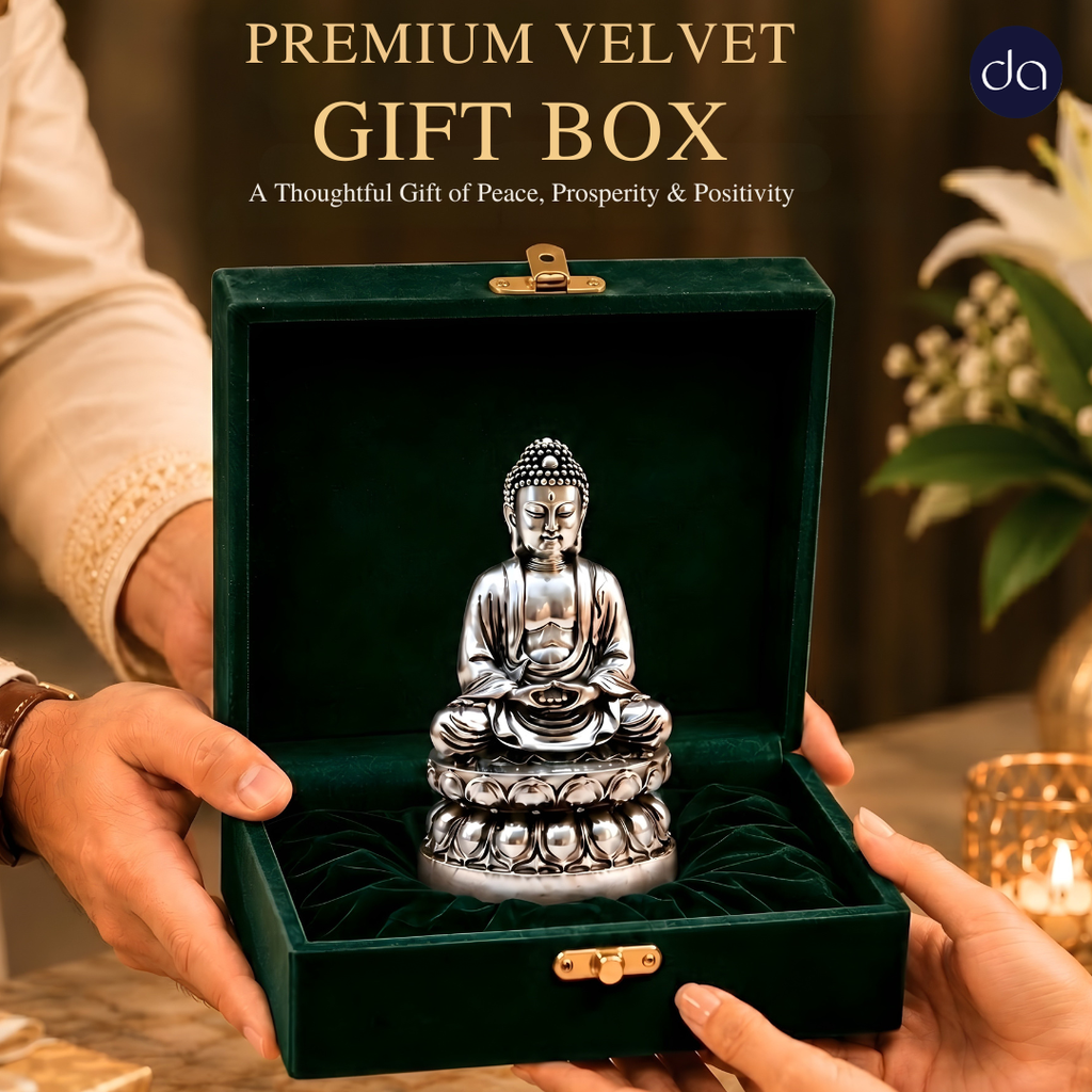 Hands gifting Buddha silver-plated idol in premium velvet gift box for peace and prosperity