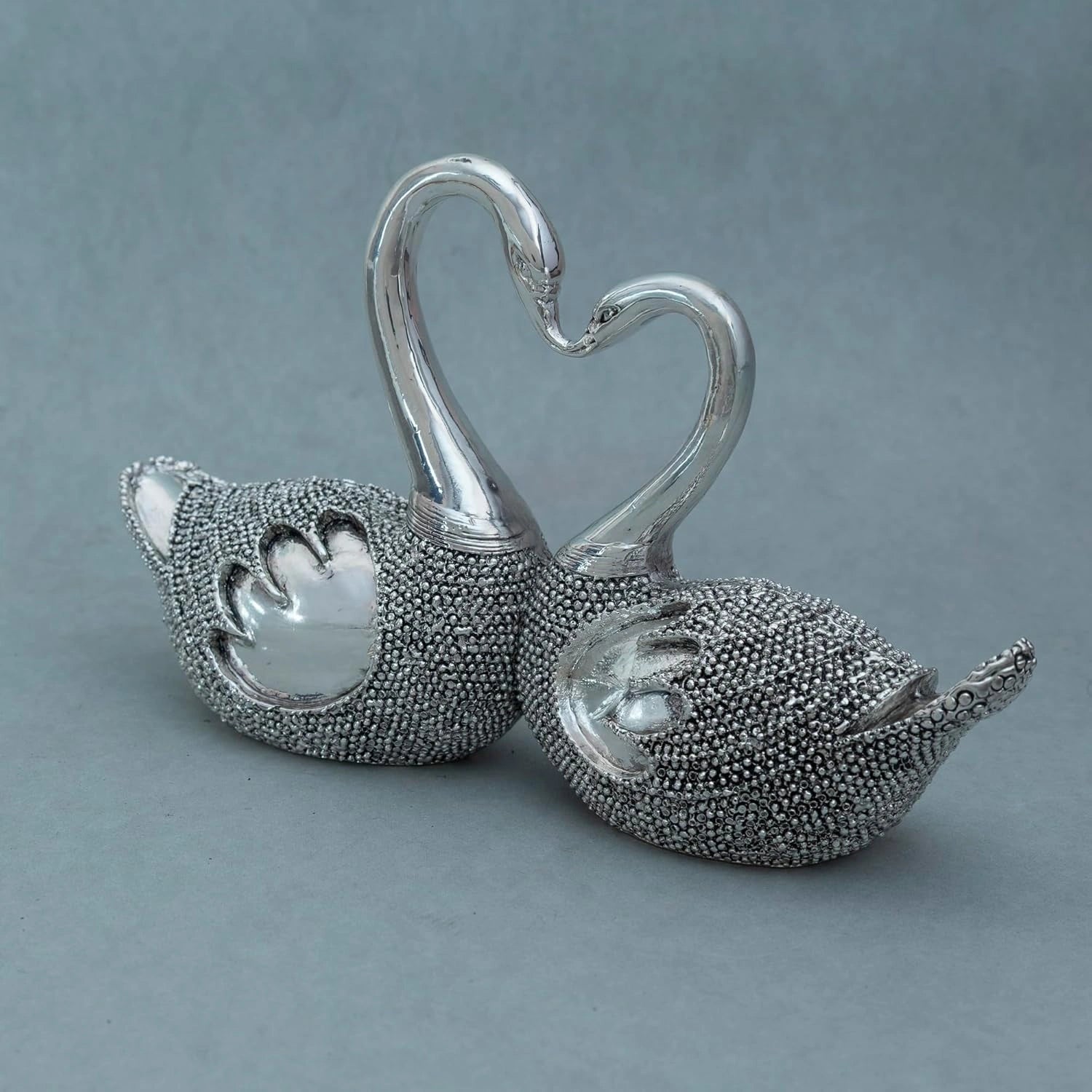 Silver lovebirds showpiece with textured bodies and necks forming a heart shape