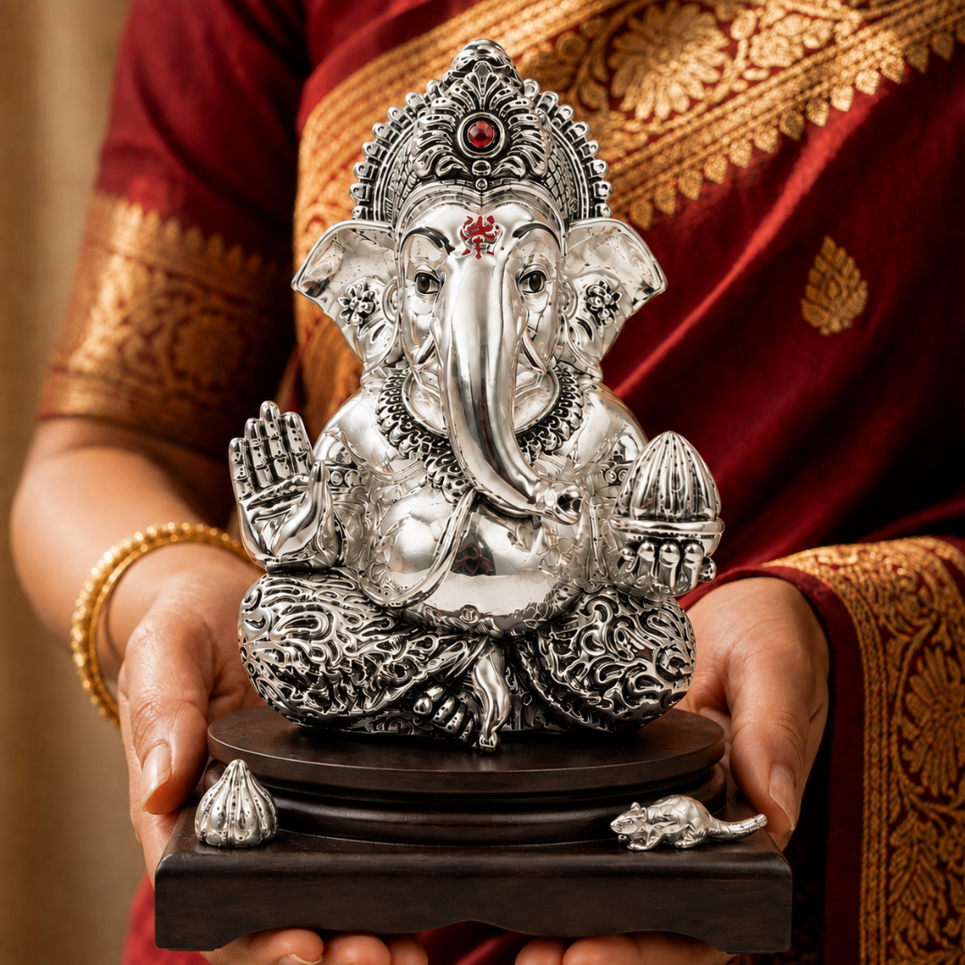 Large silver-plated Lord Ganesha idol held in hands