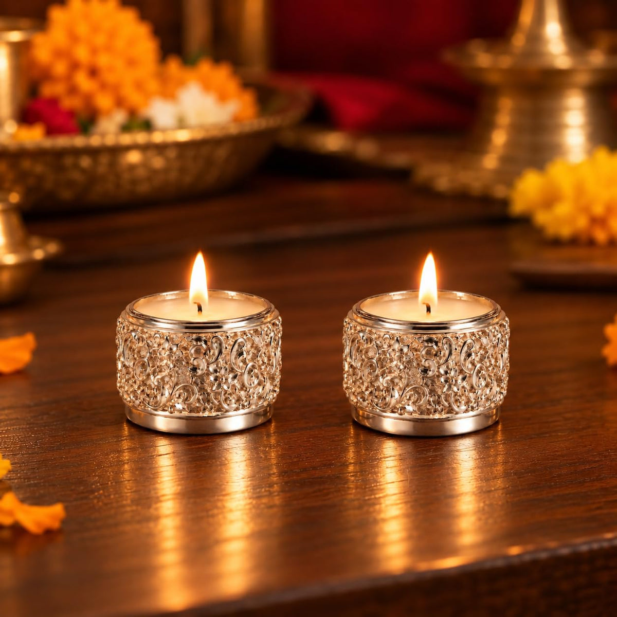 Pair of silver-plated floral tea light candle holders with lit candles