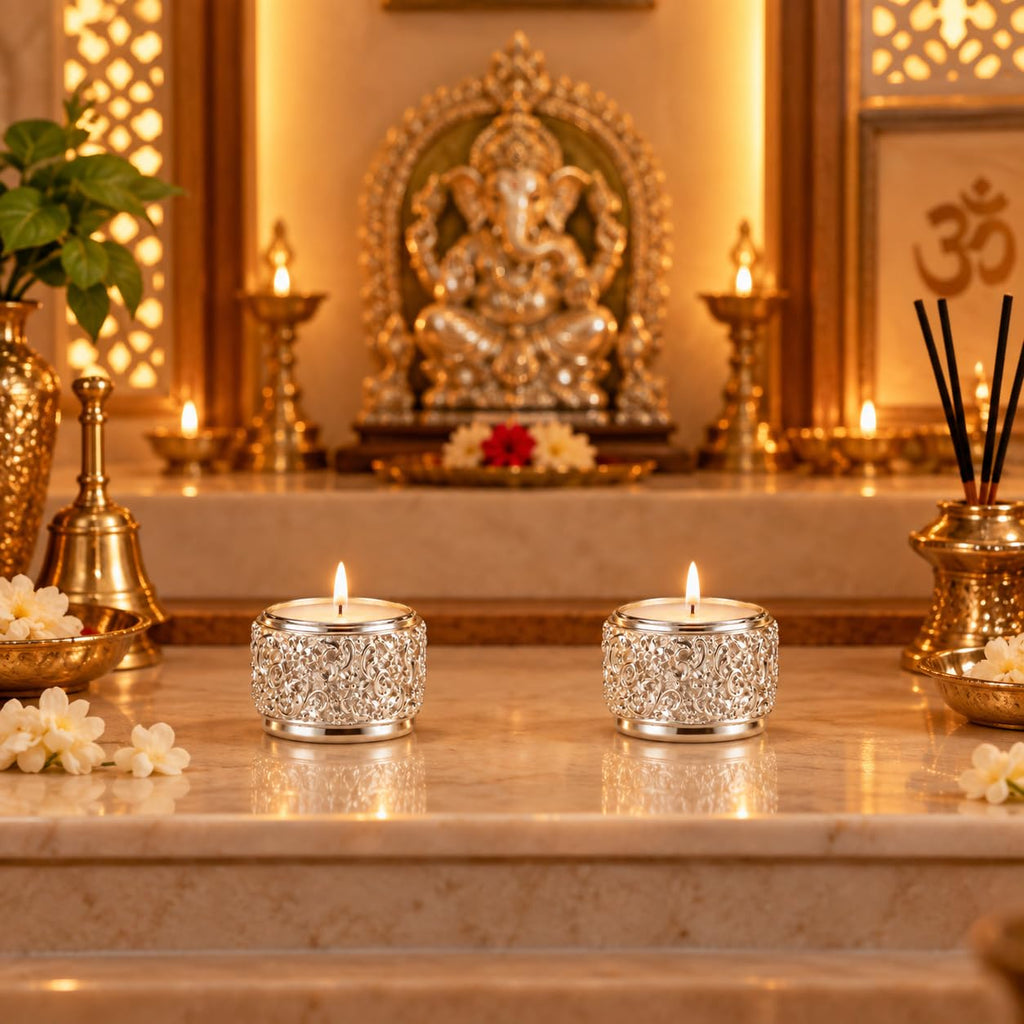 Silver-plated tea light candle holders styled in a pooja room