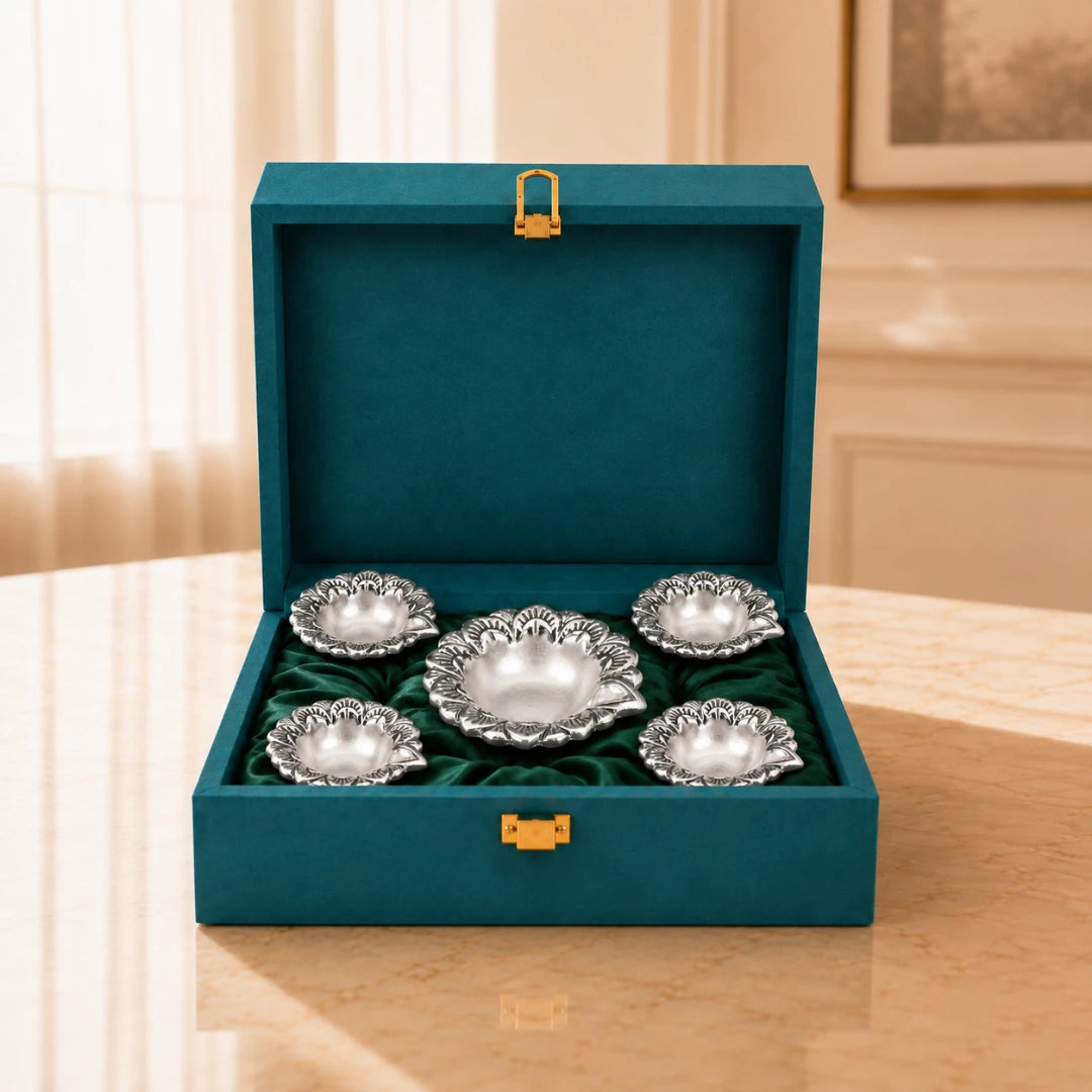 Five silver-plated flower diyas, one large and four small, on green velvet inside an open teal gift box #set-of-5