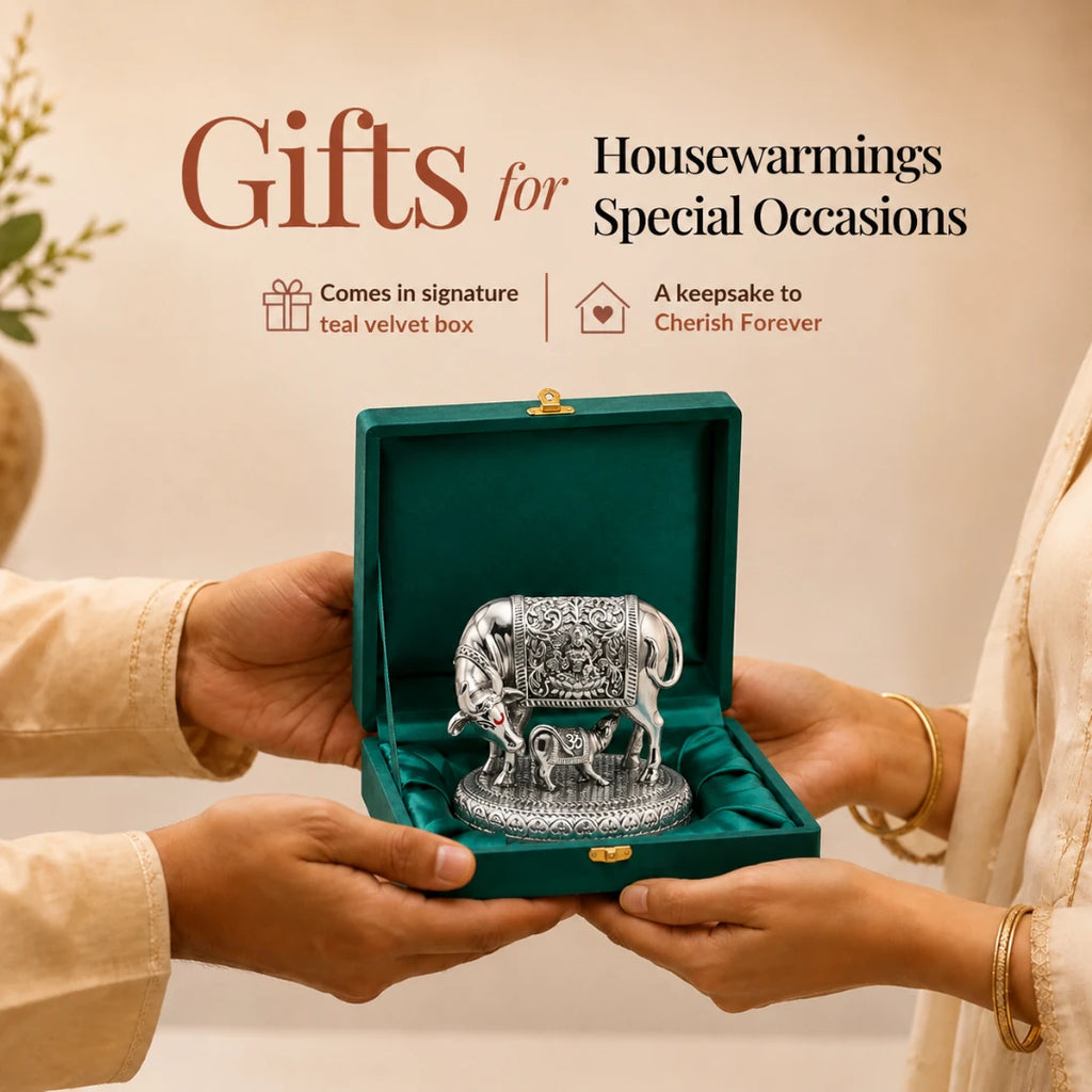 Hands presenting the 3.5 inch silver Kamdhenu cow idol in its signature teal velvet gift box #3-5-inch
