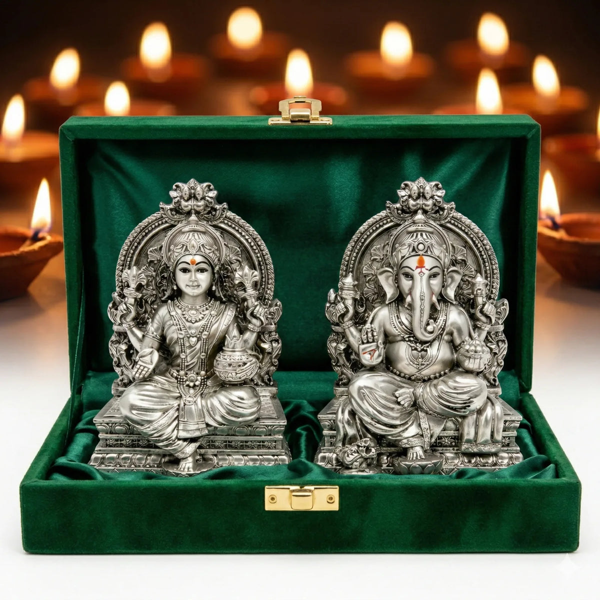 Lakshmi Ganesh silver-plated idol set in green velvet gift box surrounded by Diwali diyas