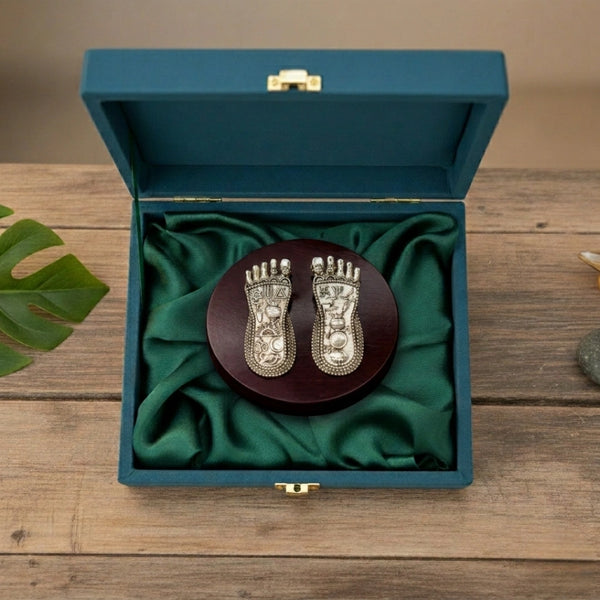 Lakshmi charan paduka silver-plated on round wooden base inside teal velvet gift box