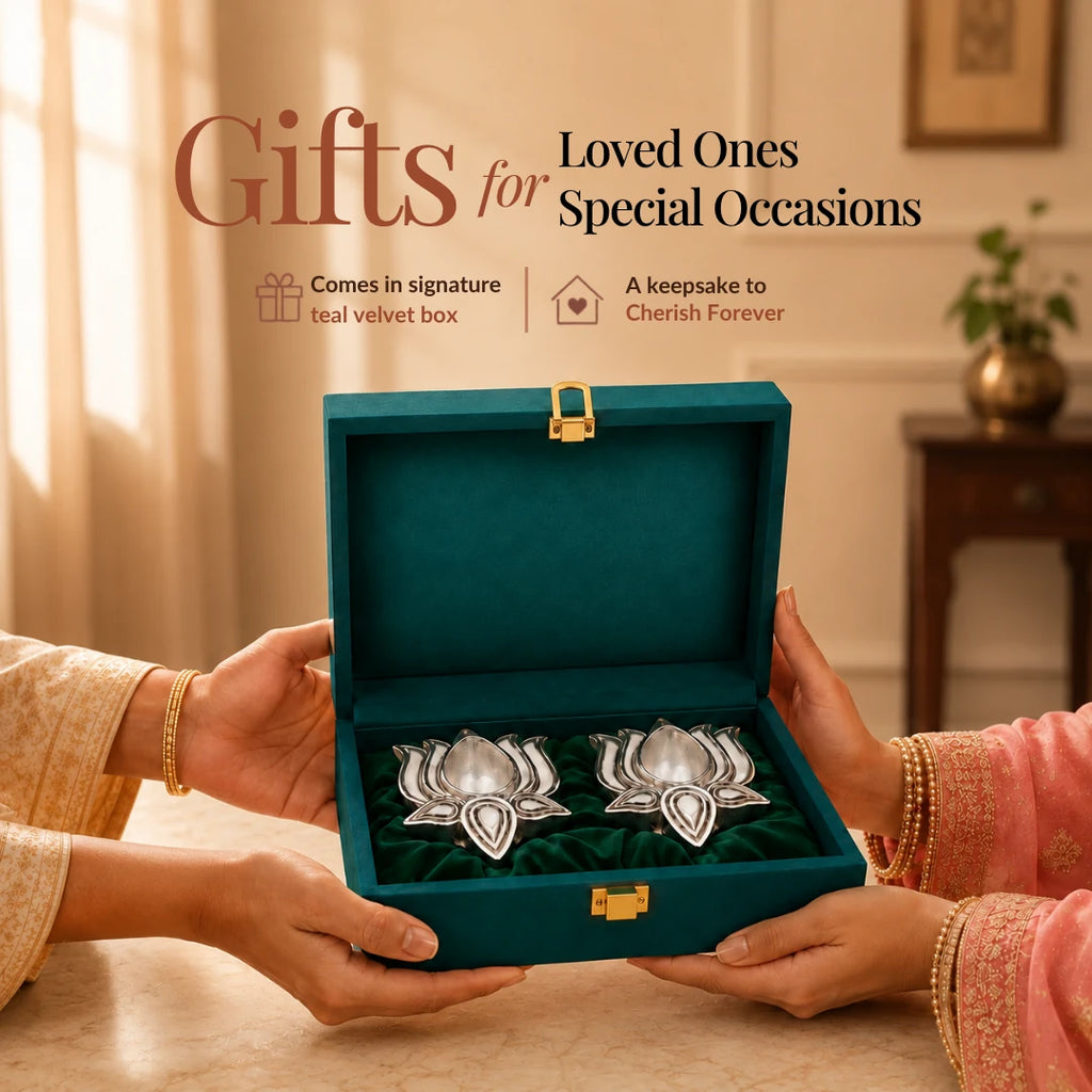 Hands presenting a teal velvet box holding two silver-plated lotus diyas #2