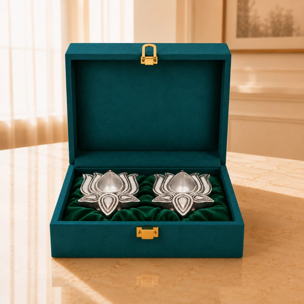 Two silver-plated lotus diyas on green velvet inside an open teal velvet gift box #2