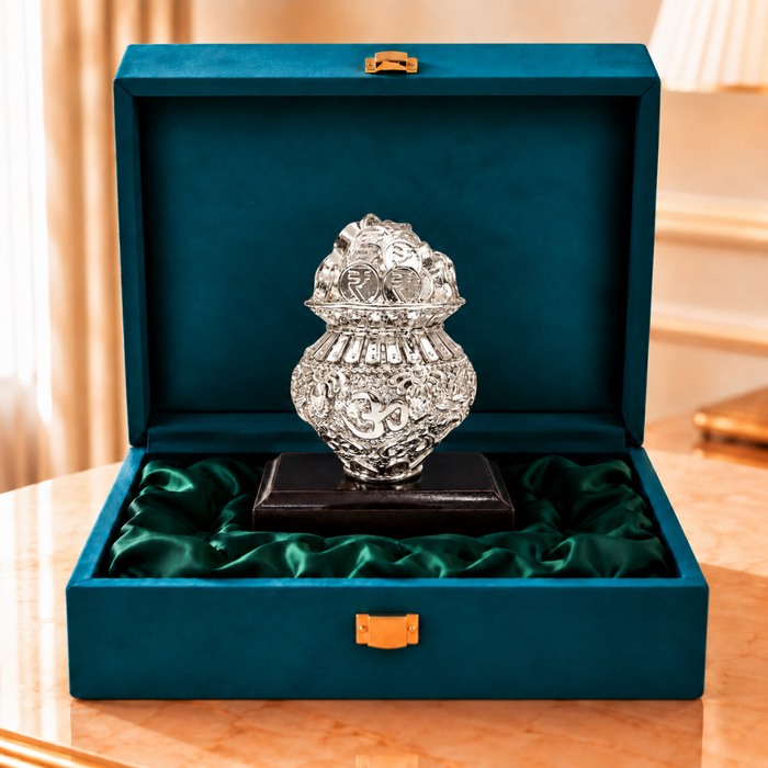 Silver-plated Kuber Kalash Khazana with Om motif on a wooden base inside an open green velvet gift box
