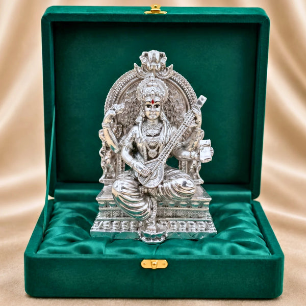Silver-plated Saraswati idol playing veena on lotus throne in green velvet gift box