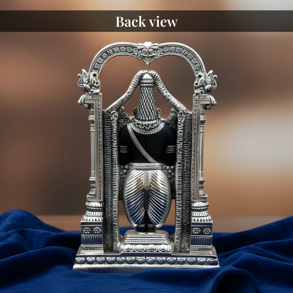 Back view of standing Tirupati Balaji silver-plated idol on royal blue velvet drape