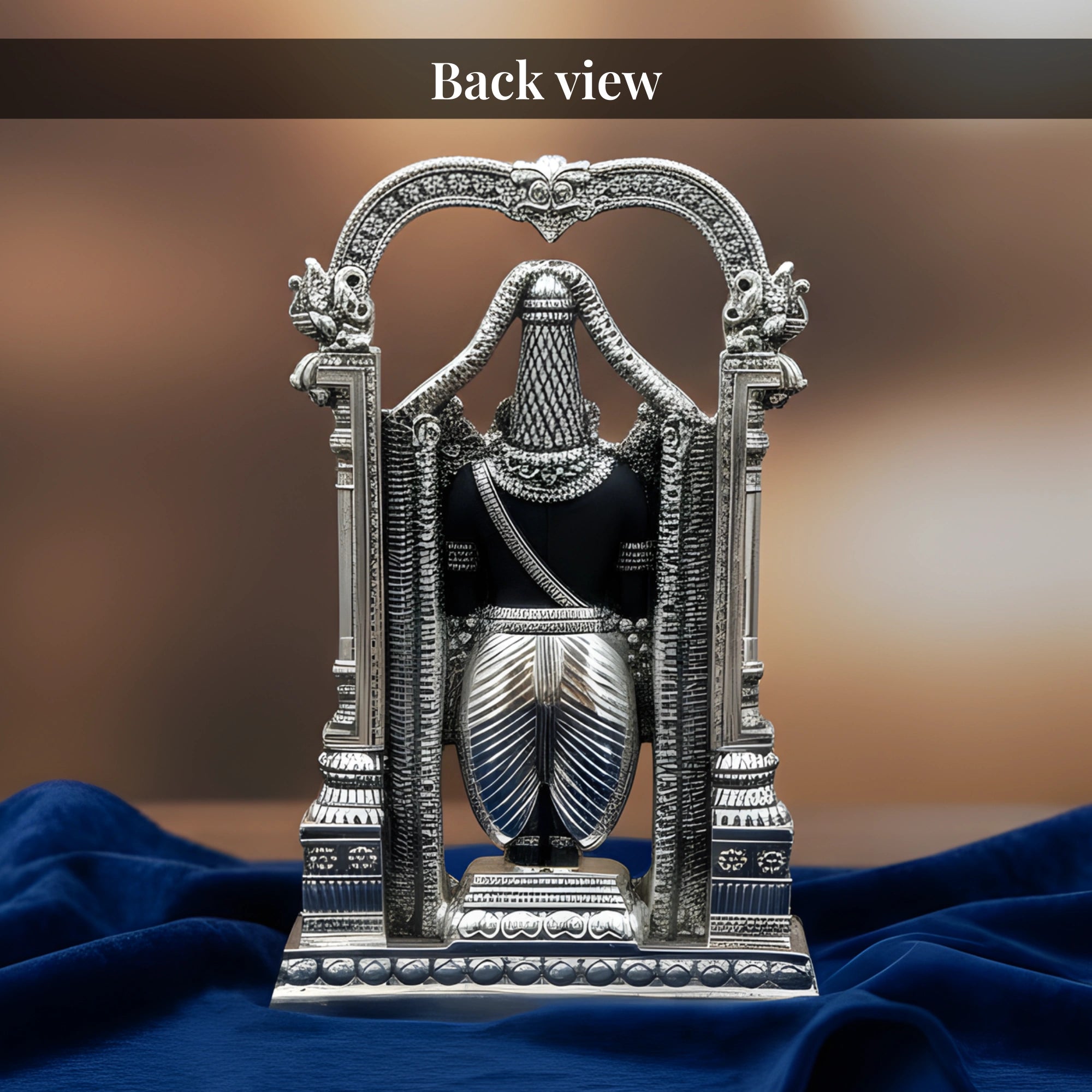 Back view of standing Tirupati Balaji silver-plated idol on royal blue velvet drape